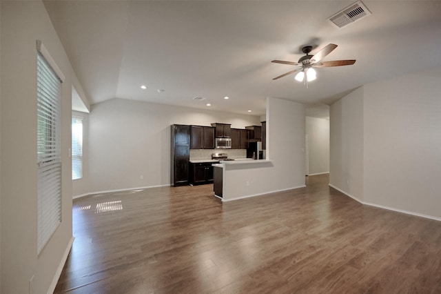9533 E Woodmark, Conroe, TX 77304 - unfurnished living room with lofted ceiling, ceiling fan, wood finished floors, baseboards, and recessed lighting