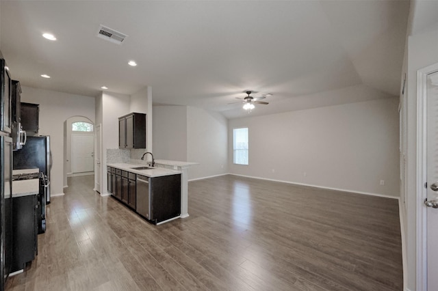 9533 E Woodmark, Conroe, TX 77304 - kitchen featuring ceiling fan, light countertops, a sink, wood finished floors, and baseboards