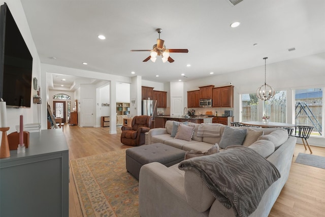 28803 Crested Butte Dr, Katy, TX 77494 - living area featuring a ceiling fan, light wood-type flooring, recessed lighting, and a chandelier