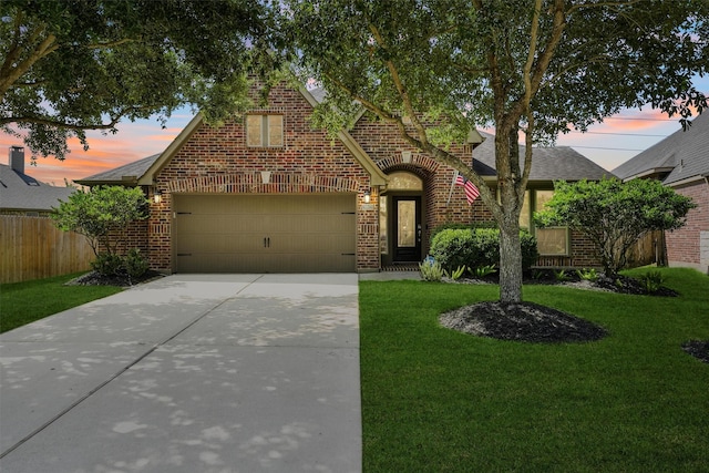 28803 Crested Butte Dr, Katy, TX 77494 - tudor home featuring brick siding, concrete driveway, a garage, and a shingled roof