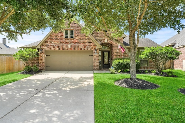 28803 Crested Butte Dr, Katy, TX 77494 - tudor house with brick siding, concrete driveway, a shingled roof, and an attached garage