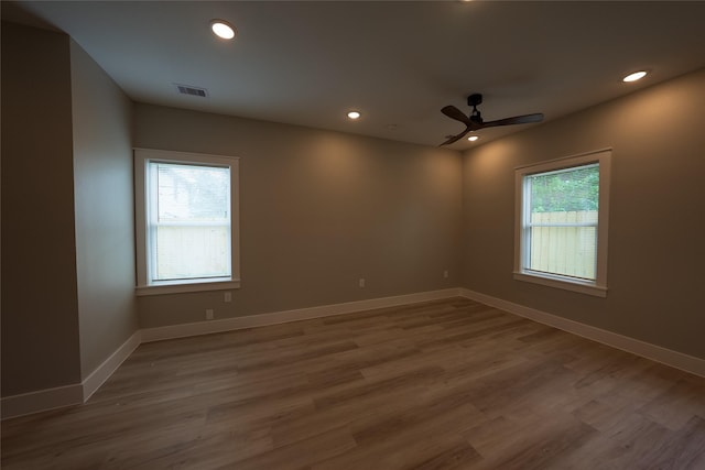 unfurnished room featuring plenty of natural light, recessed lighting, wood finished floors, and a ceiling fan