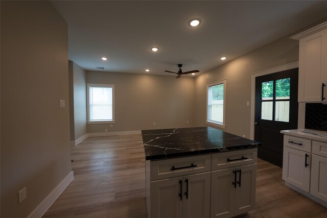 kitchen featuring healthy amount of natural light, light wood-style floors, baseboards, and recessed lighting