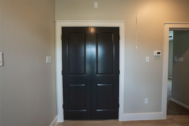 entryway with baseboards and wood finished floors