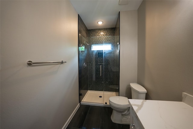 full bath featuring toilet, a shower stall, vanity, wood finished floors, and baseboards