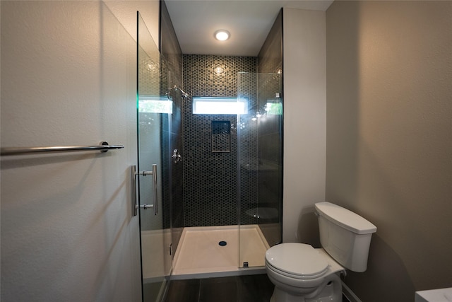 full bathroom featuring toilet and a stall shower