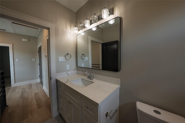 bathroom with vanity, toilet, and baseboards