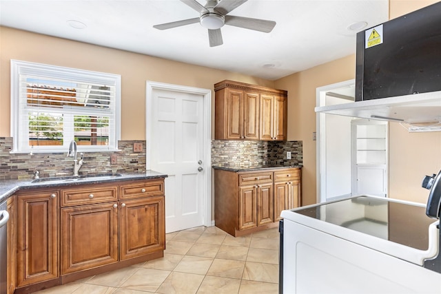 1741 Gardenia Dr, Houston, TX 77018 - kitchen with a sink, brown cabinetry, tasteful backsplash, and a ceiling fan