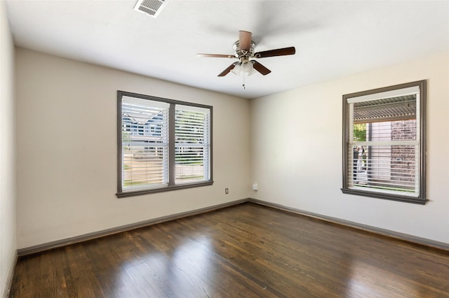 1741 Gardenia Dr, Houston, TX 77018 - unfurnished room with dark wood-style floors, ceiling fan, and baseboards