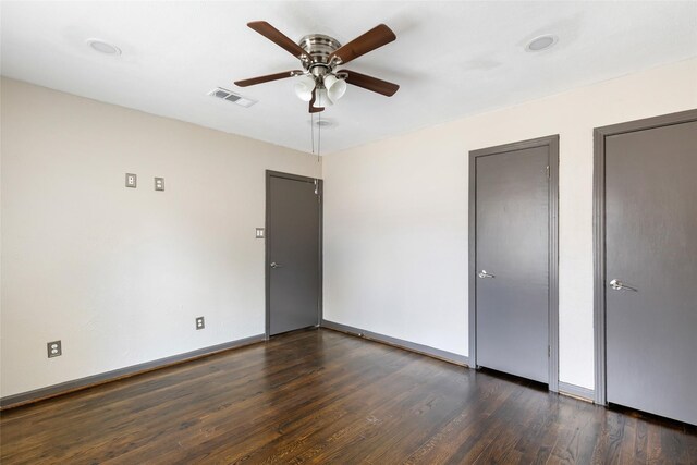 1741 Gardenia Dr, Houston, TX 77018 - unfurnished bedroom featuring dark wood-style flooring, baseboards, ceiling fan, and multiple closets