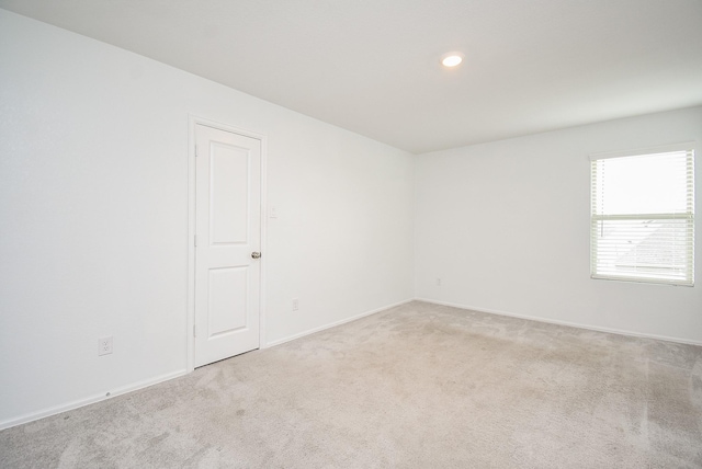 7303 Dover View Ln, Katy, TX 77493 - spare room featuring light carpet, baseboards, and recessed lighting