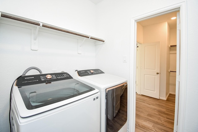 7303 Dover View Ln, Katy, TX 77493 - laundry area featuring washer and clothes dryer, light wood-type flooring, and baseboards