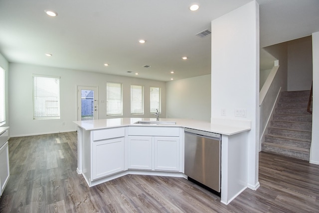 7303 Dover View Ln, Katy, TX 77493 - kitchen featuring stainless steel dishwasher, a sink, wood finished floors, light countertops, and recessed lighting