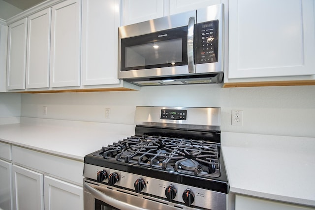 7303 Dover View Ln, Katy, TX 77493 - kitchen with stainless steel appliances, light countertops, and white cabinets