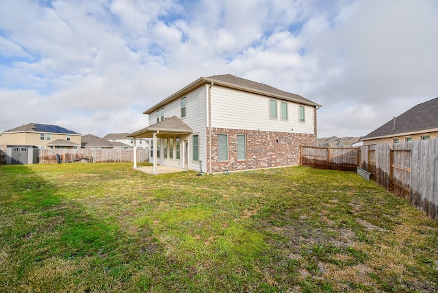 7303 Dover View Ln, Katy, TX 77493 - back of property with brick siding, a patio, a storage shed, and an outbuilding