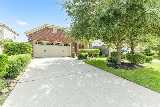 27 Canterborough Pl, Tomball, TX 77375 - view of front of house with brick siding, concrete driveway, and an attached garage