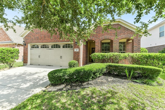 27 Canterborough Pl, Tomball, TX 77375 - traditional-style home with brick siding, driveway, and an attached garage