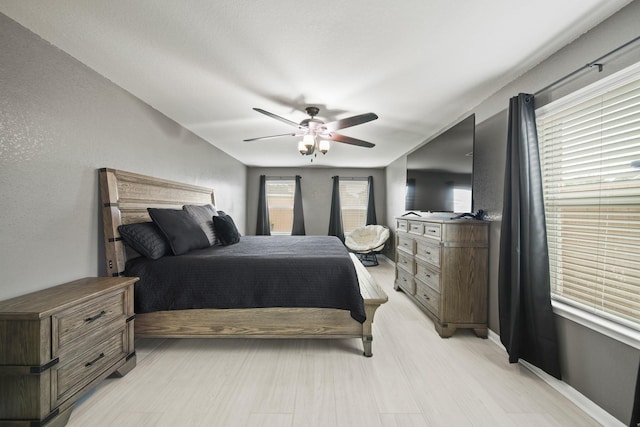 bedroom with ceiling fan and light wood-style flooring