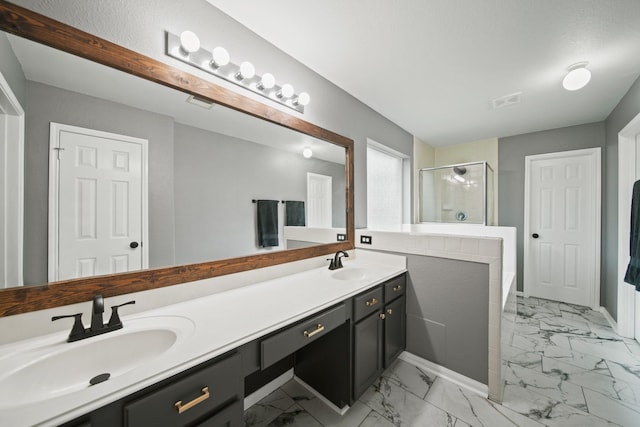 bathroom with marble look tiles, a shower stall, double vanity, and a tub to relax in