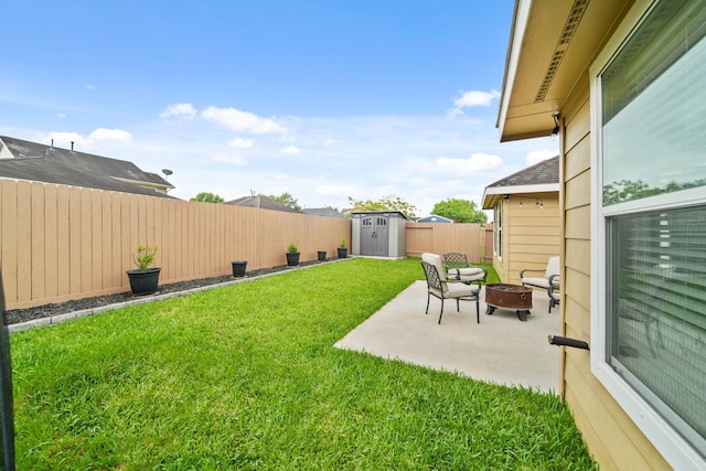 view of yard featuring an outdoor fire pit, a storage unit, a patio, and an outdoor structure