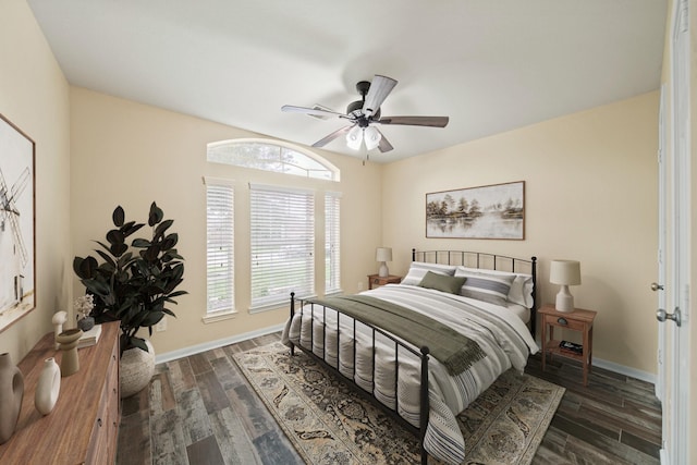 bedroom with dark wood finished floors, baseboards, and ceiling fan