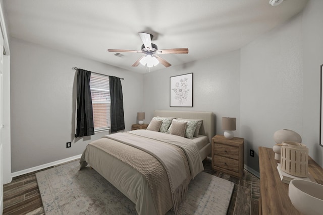 bedroom with baseboards, wood finished floors, and a ceiling fan