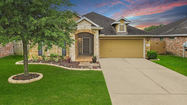 view of front of home featuring an attached garage, concrete driveway, a shingled roof, brick siding, and stone siding