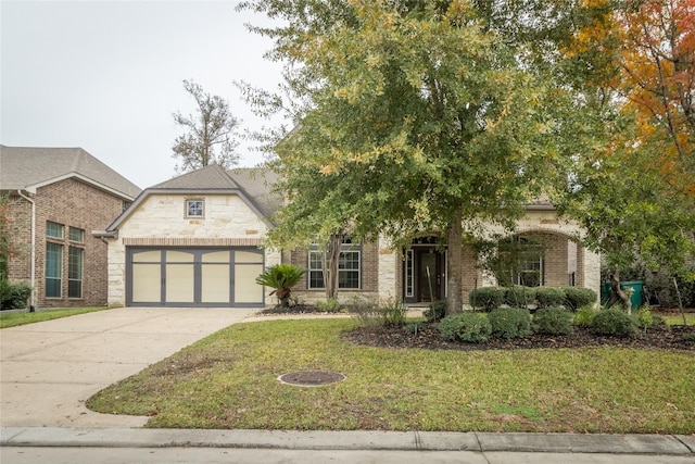 view of front facade featuring a garage, a front lawn, concrete driveway, stone siding, and brick siding