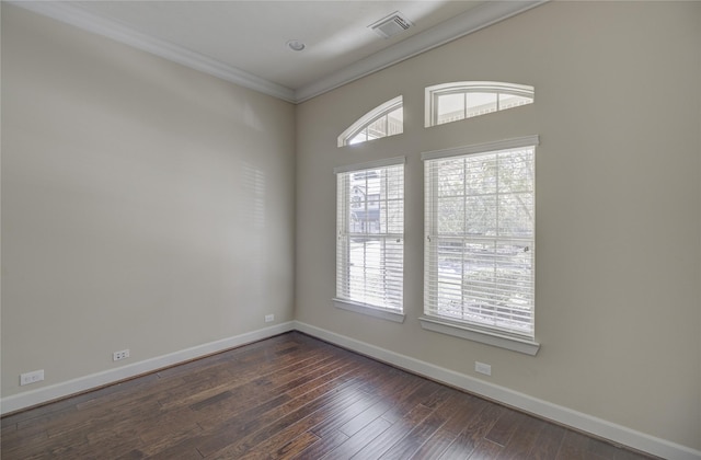 unfurnished room with baseboards, dark wood-type flooring, and crown molding