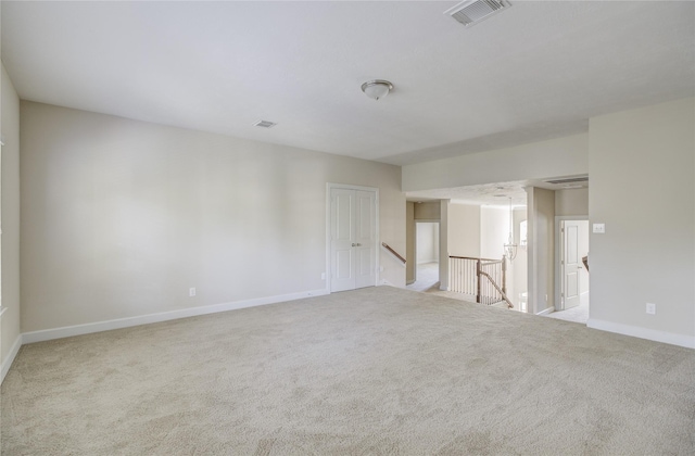carpeted spare room with baseboards