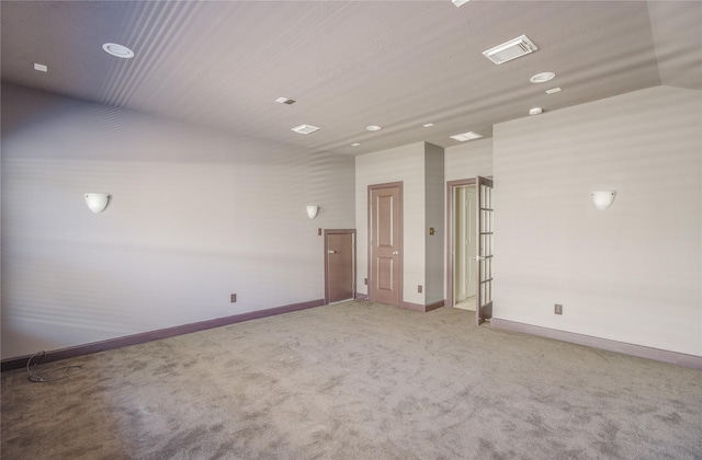 empty room featuring baseboards, light colored carpet, and recessed lighting