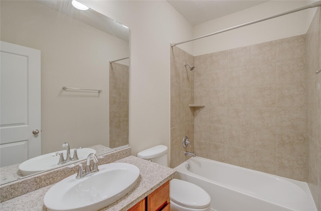 bathroom with toilet, vanity, and shower / bath combination