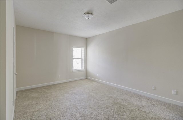 carpeted empty room with baseboards