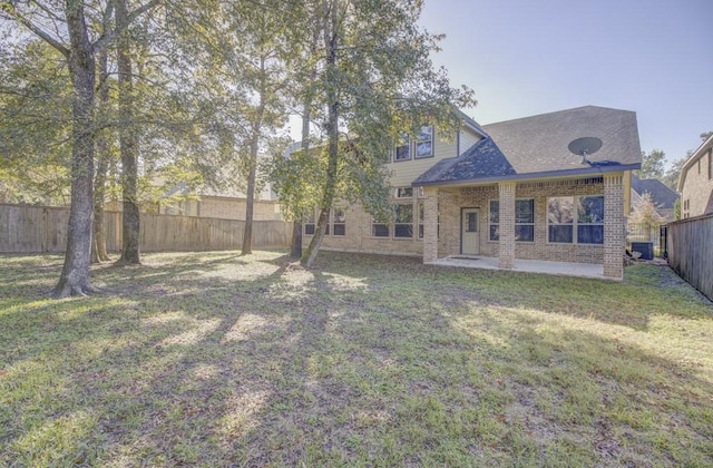back of house featuring a patio, brick siding, central AC, and roof with shingles