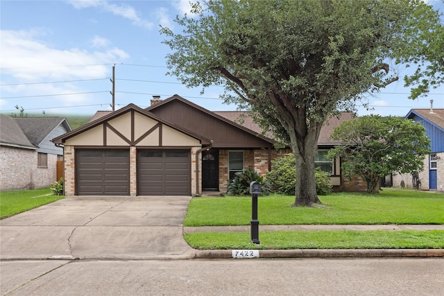view of front of property with a garage, a front lawn, driveway, brick siding, and a chimney