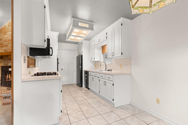 kitchen featuring black appliances, a sink, light countertops, and white cabinets