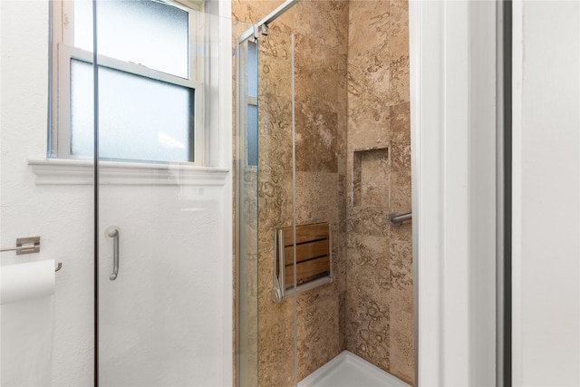 full bath with a stall shower and plenty of natural light