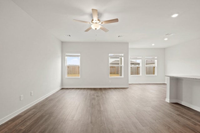 11664 Wilgers Way, Willis, TX 77378 - unfurnished living room featuring ceiling fan, baseboards, wood finished floors, and recessed lighting