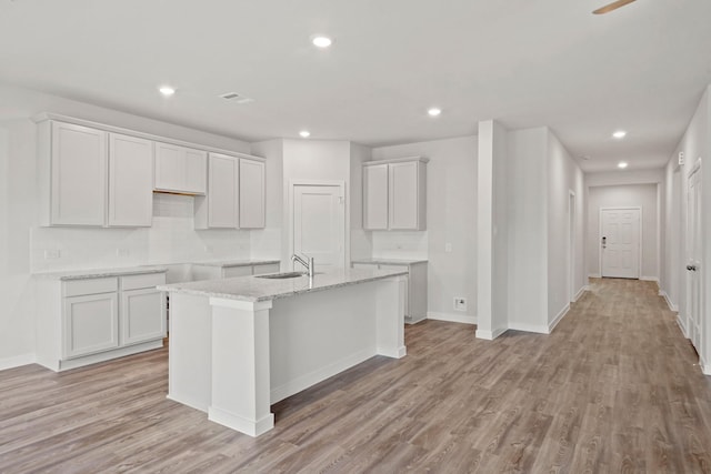 11664 Wilgers Way, Willis, TX 77378 - kitchen featuring a sink, a center island with sink, light wood-style flooring, recessed lighting, and baseboards