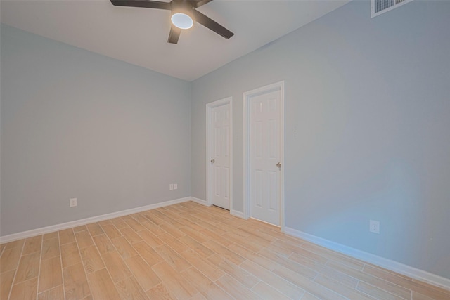 unfurnished bedroom featuring light wood-style floors, baseboards, and a ceiling fan