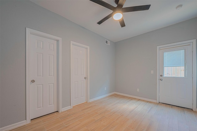 spare room featuring a ceiling fan, light wood-type flooring, baseboards, and a smoke detector