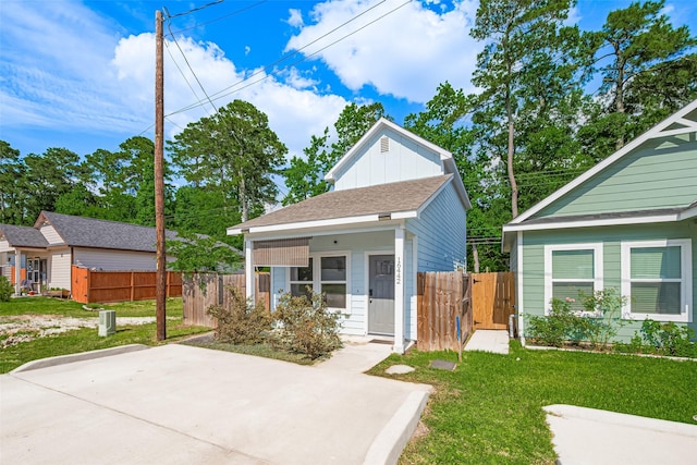 view of front of home with a gate, board and batten siding, and a patio area