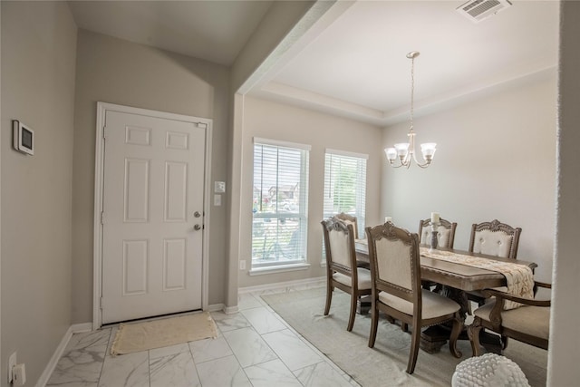 14707 Fairy Tern Ln, Houston, TX 77049 - dining room featuring light marble finish floors, a chandelier, baseboards, and a raised ceiling