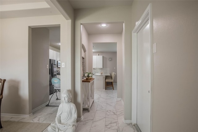 14707 Fairy Tern Ln, Houston, TX 77049 - corridor featuring light marble finish flooring and baseboards