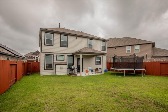 14707 Fairy Tern Ln, Houston, TX 77049 - back of house featuring a trampoline and a patio