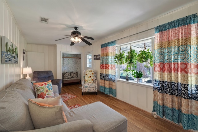 111 Circle Dr, Cleveland, TX 77327 - living area featuring a decorative wall, wood finished floors, and a ceiling fan