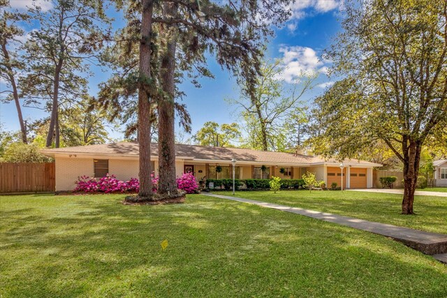 111 Circle Dr, Cleveland, TX 77327 - ranch-style house featuring an attached garage and driveway