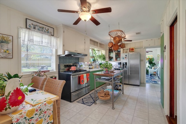 111 Circle Dr, Cleveland, TX 77327 - kitchen featuring stainless steel appliances, under cabinet range hood, ceiling fan, decorative backsplash, and light tile patterned flooring
