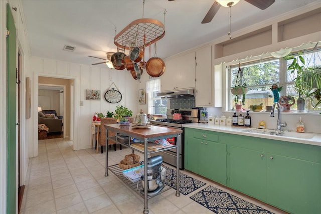 111 Circle Dr, Cleveland, TX 77327 - kitchen featuring stainless steel range with gas cooktop, a ceiling fan, under cabinet range hood, and light countertops