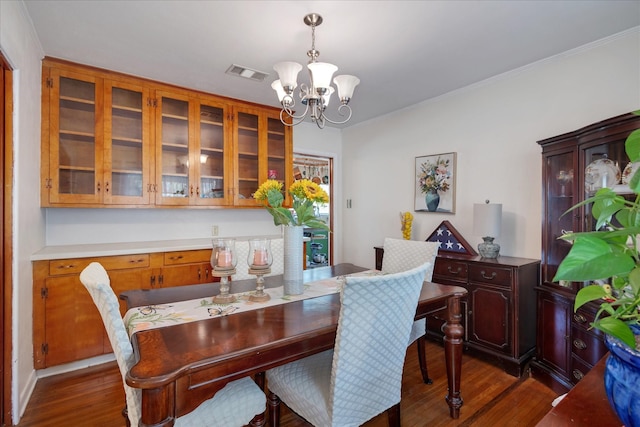 111 Circle Dr, Cleveland, TX 77327 - dining space featuring dark wood-type flooring, a chandelier, and crown molding